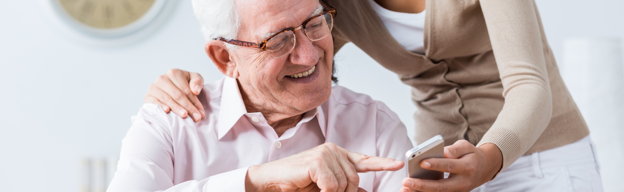 Elderly-Man-Smiling-at-Phone Elderly-Man Smiling-at-Phone