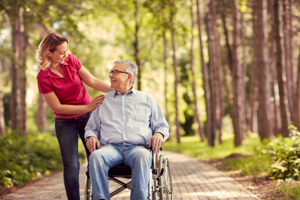 Young-woman-Helping-Elderly-Man Young-woman-Helping-Elderly-Man
