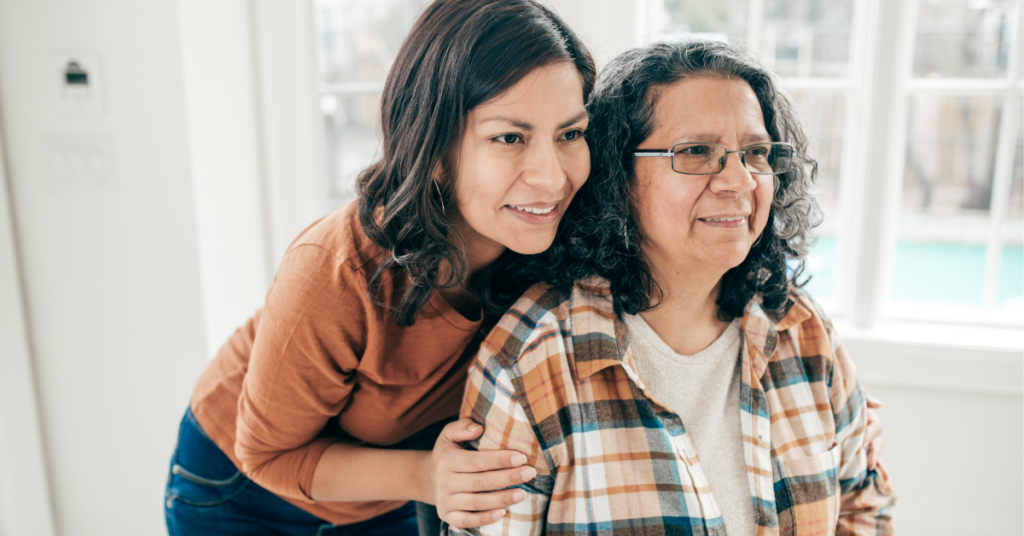 woman holding older mother's shoulders
