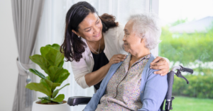 middle-aged adult woman speaking with elderly mother who is in a wheelchair