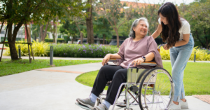 caregiver pushing her older mother in a wheelchair